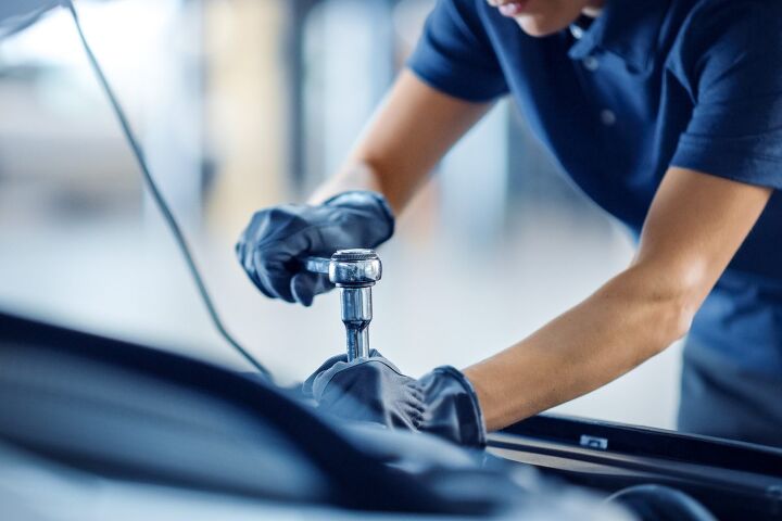 A mechanic works on a vehicle that's under ASC Warranty protection.