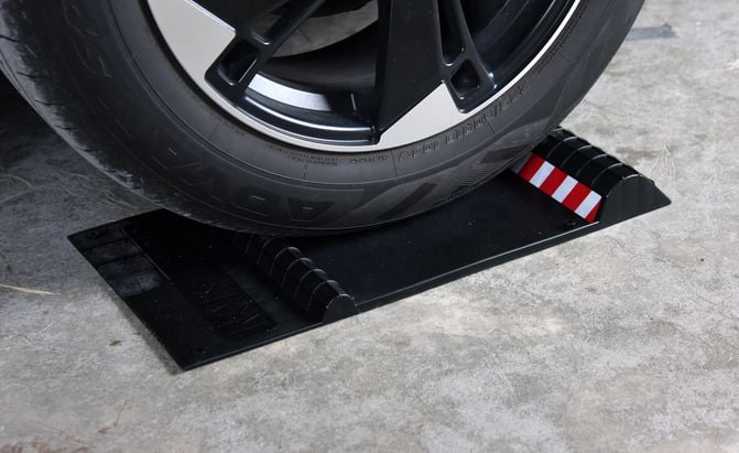 rubber parking mat under a wheel on a garage floor