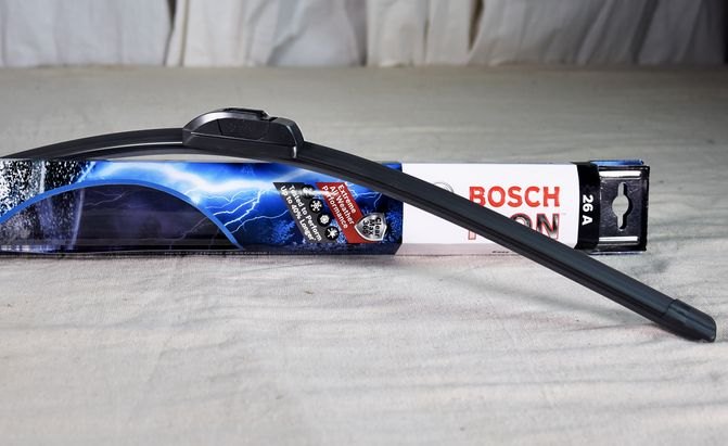 a bosch icon wiper blade draped seductively over its box on a table