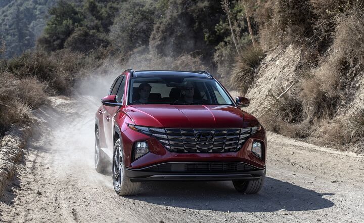 2022 Hyundai Tucson in red dynamic dirt road shot