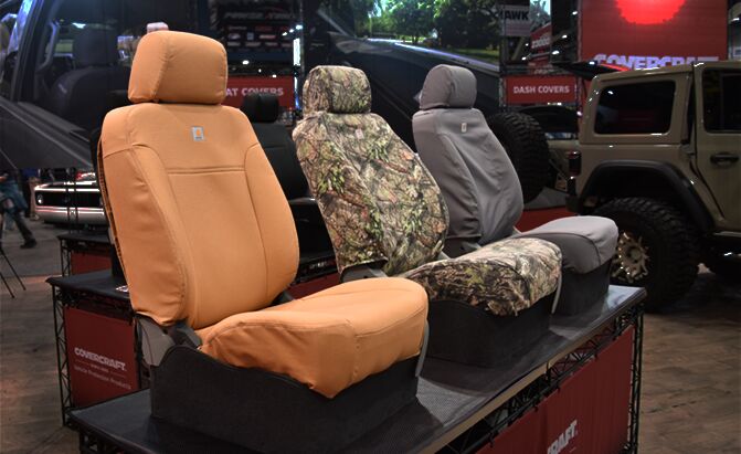 three truck seats on a table with seat covers installed
