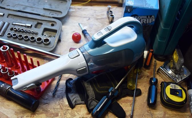 a black and decker dustbuster vacuum on a shop tool bench