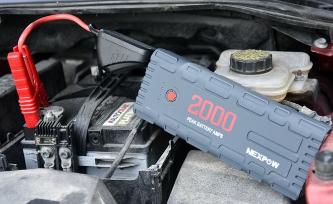 nexpow 2000a jump starter in a dirty mazda engine bay