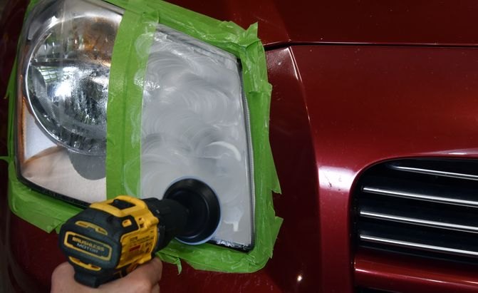 buffing a headlight lens with an impact driver and buffing ball