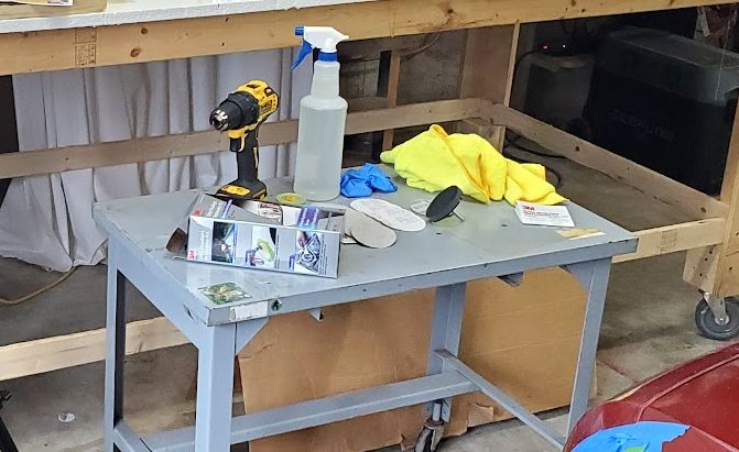 headlight restoration kit and equipment on a work bench