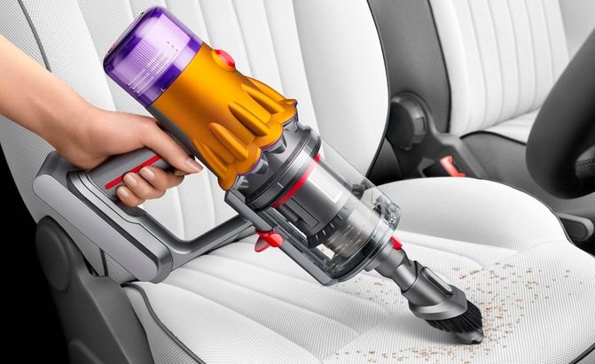 Dyson V12 Detect Slim vacuuming a car seat